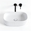Ceramic oval sink with ribbed design and matte black faucet finish 40 x 25 x 12cm